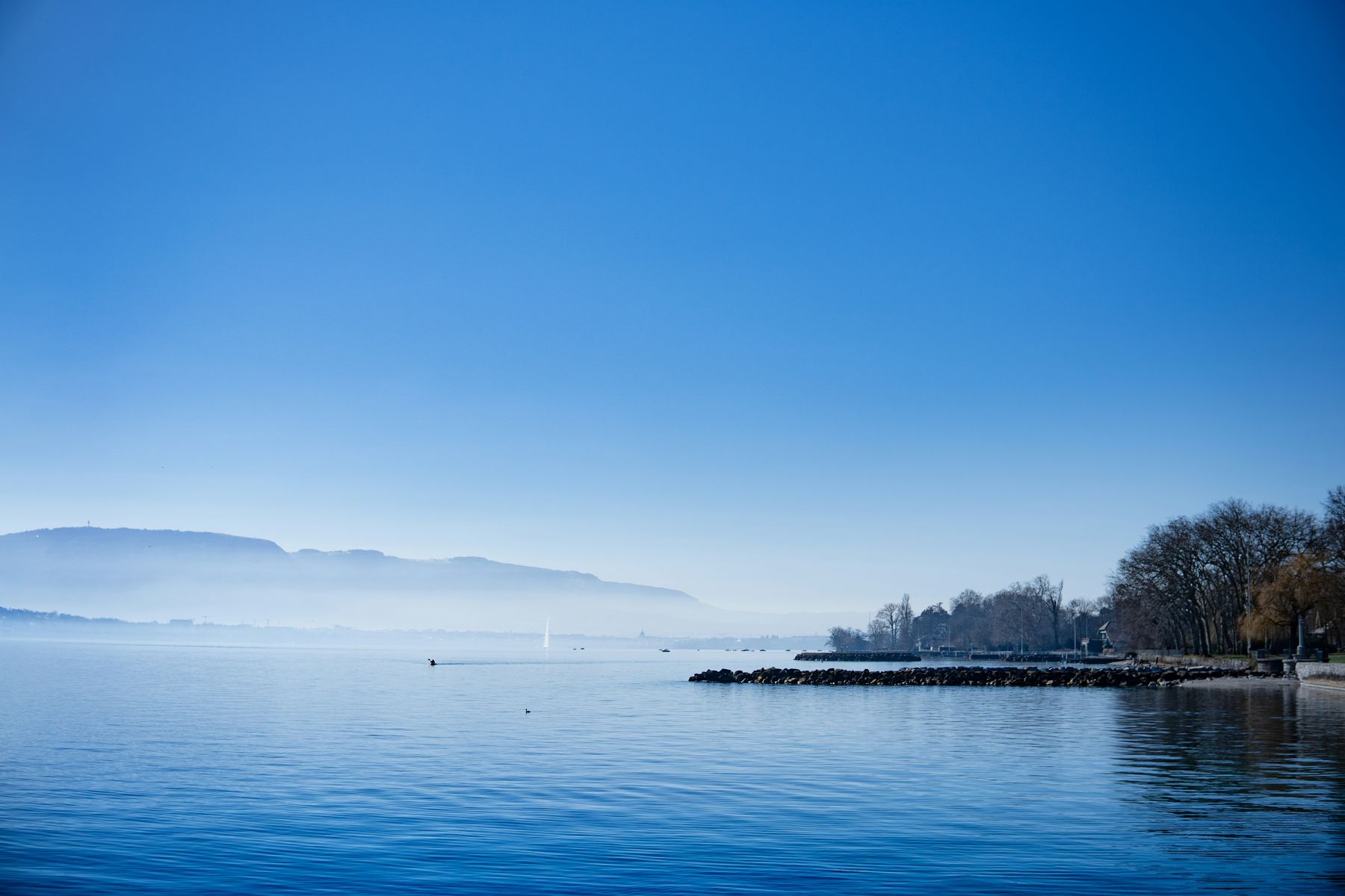 Lake Geneva on a clear day, the far shore in haze
